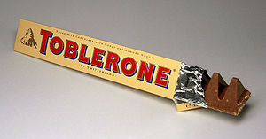 A photograph of Toblerone candy with two of them
sticking out from the edge of the triangular box.