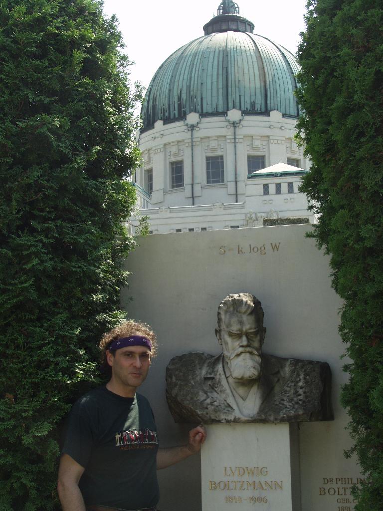 Vienna, Austria. Boltzmann's Tomb in the Zentralfriedhof (Central Cemetary). The Tomb is in Gruppe 14 C Grab No 1 (group 14 grave number 1). Photos by Tom Schneider or of him by Gerd Muller. 2002 July 14. This image: Tom Schneider with bust of Boltzmann. <a href = 