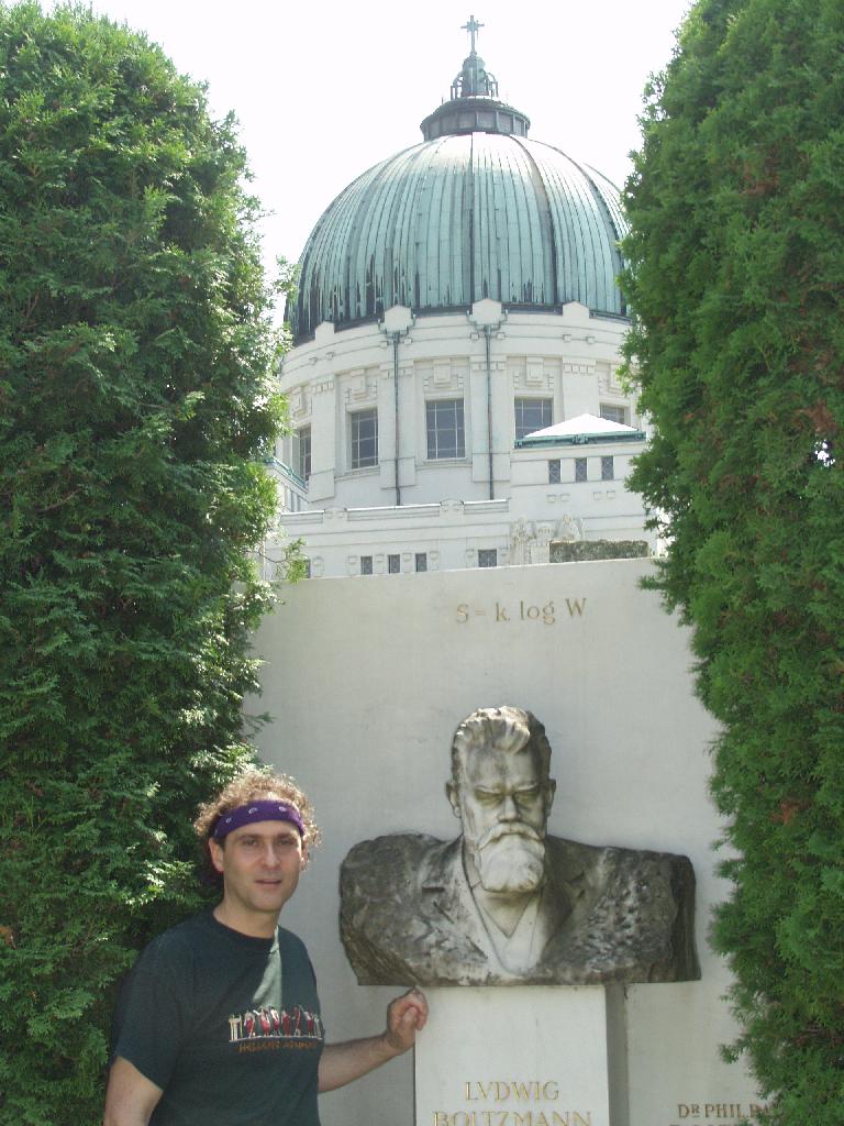 Vienna, Austria. Boltzmann's Tomb in the Zentralfriedhof (Central Cemetary). The Tomb is in Gruppe 14 C Grab No 1 (group 14 grave number 1). Photos by Tom Schneider or of him by Gerd Muller. 2002 July 14. This image: Tom Schneider with bust of Boltzmann. <a href = 