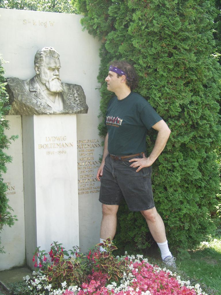 Vienna, Austria. Boltzmann's Tomb in the Zentralfriedhof (Central Cemetary). The Tomb is in Gruppe 14 C Grab No 1 (group 14 grave number 1). Photos by Tom Schneider or of him by Gerd Muller. 2002 July 14. This image: Tom Schneider with bust of Boltzmann. <a href = 
